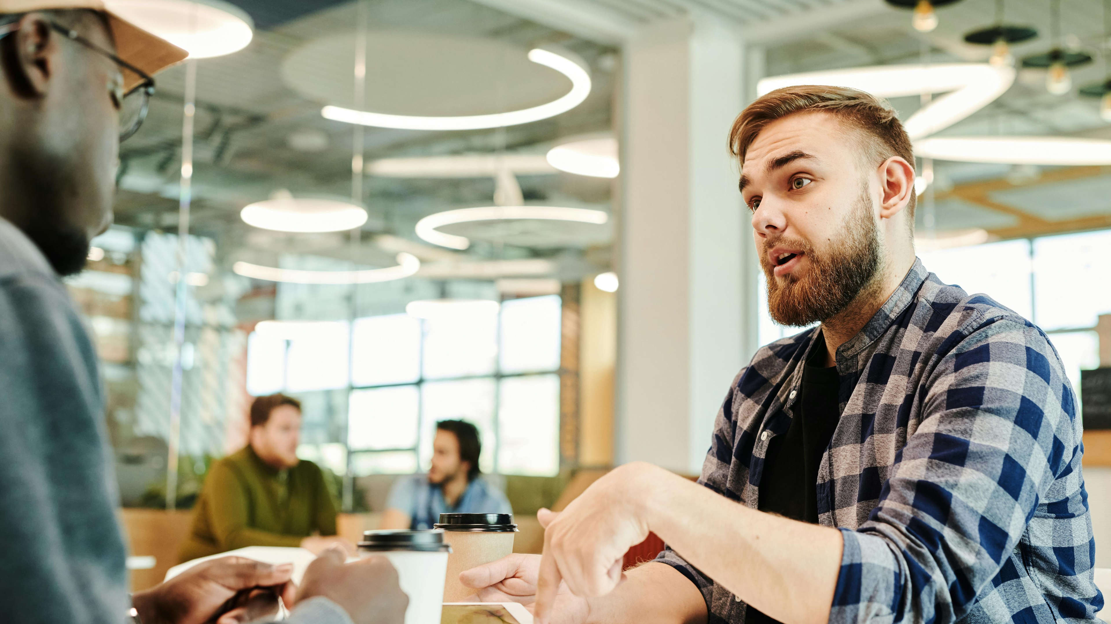 Two Men Talking at a Table in an Office