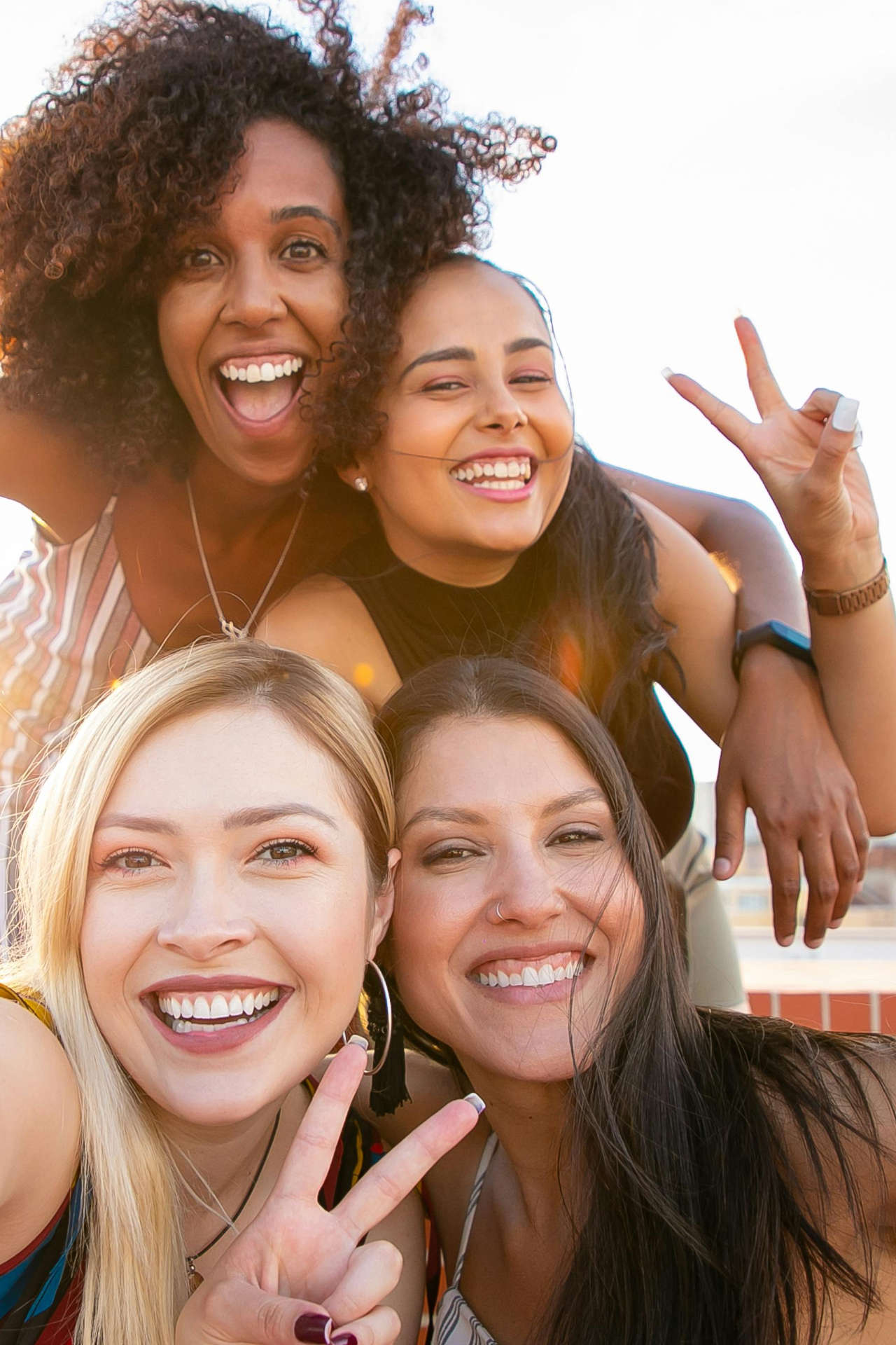 Happy Women Smiling and Showing Peace Sign