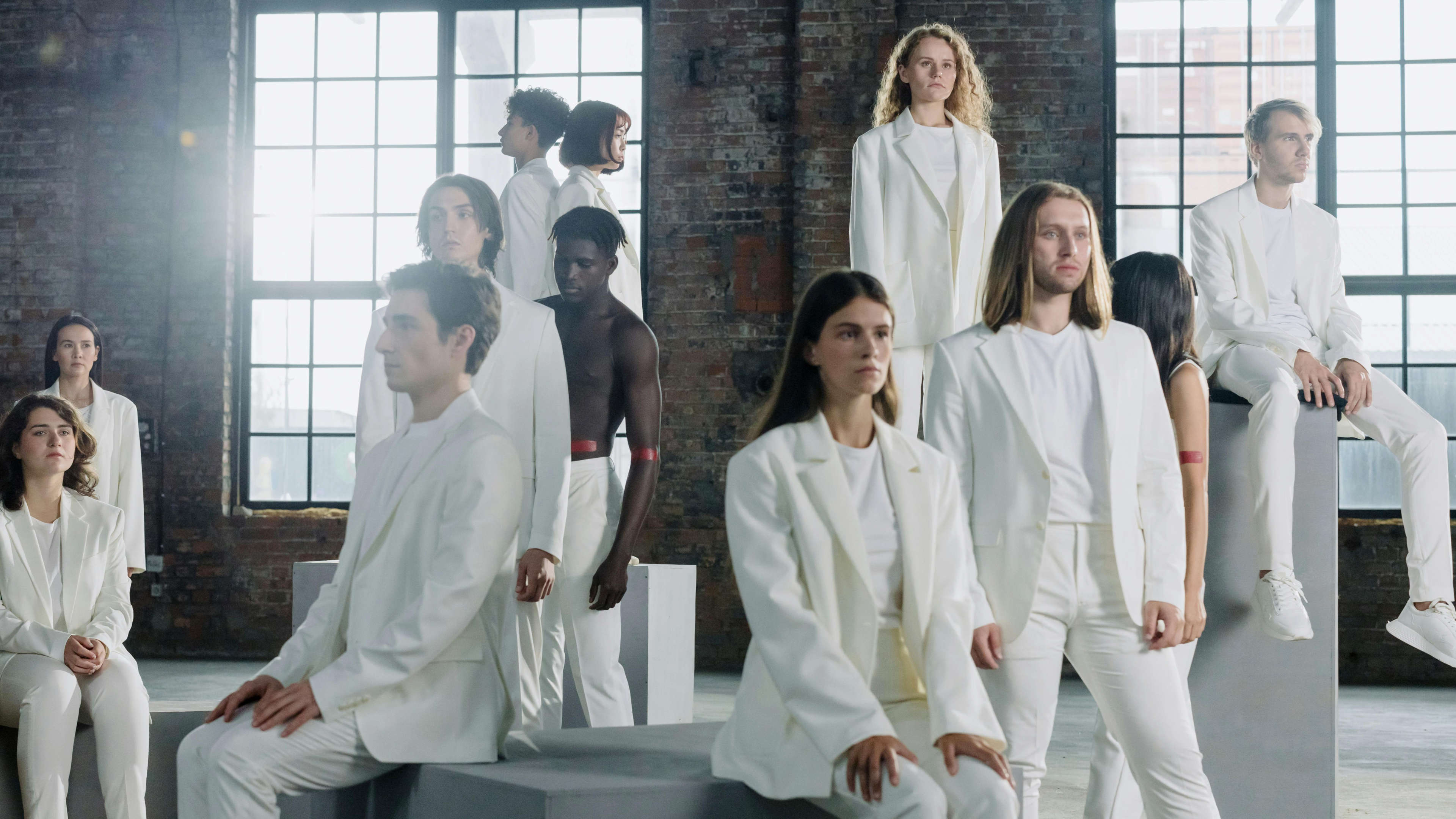 Room of People in White Posing By a Window