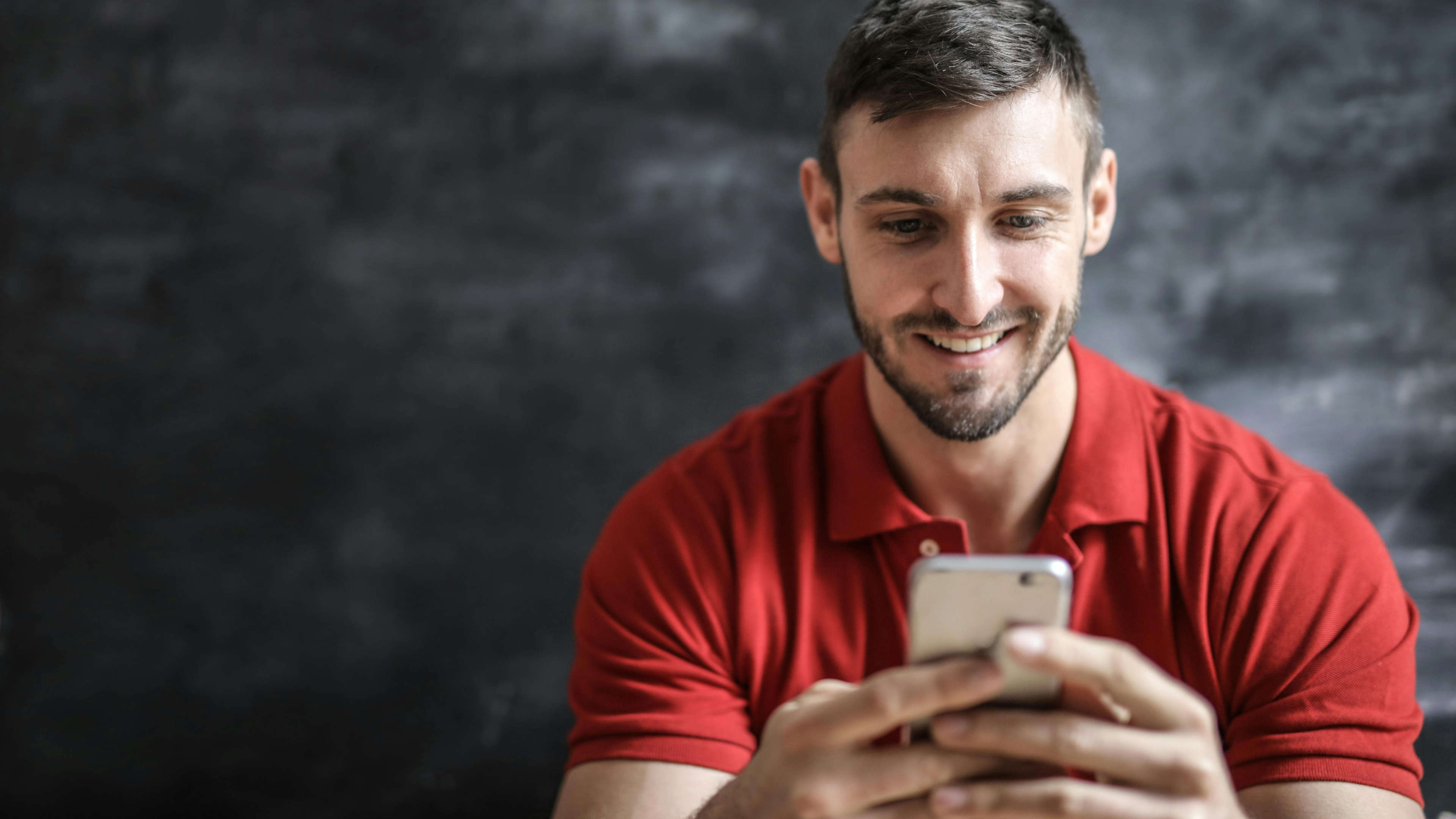 Smiling Man Using Phone