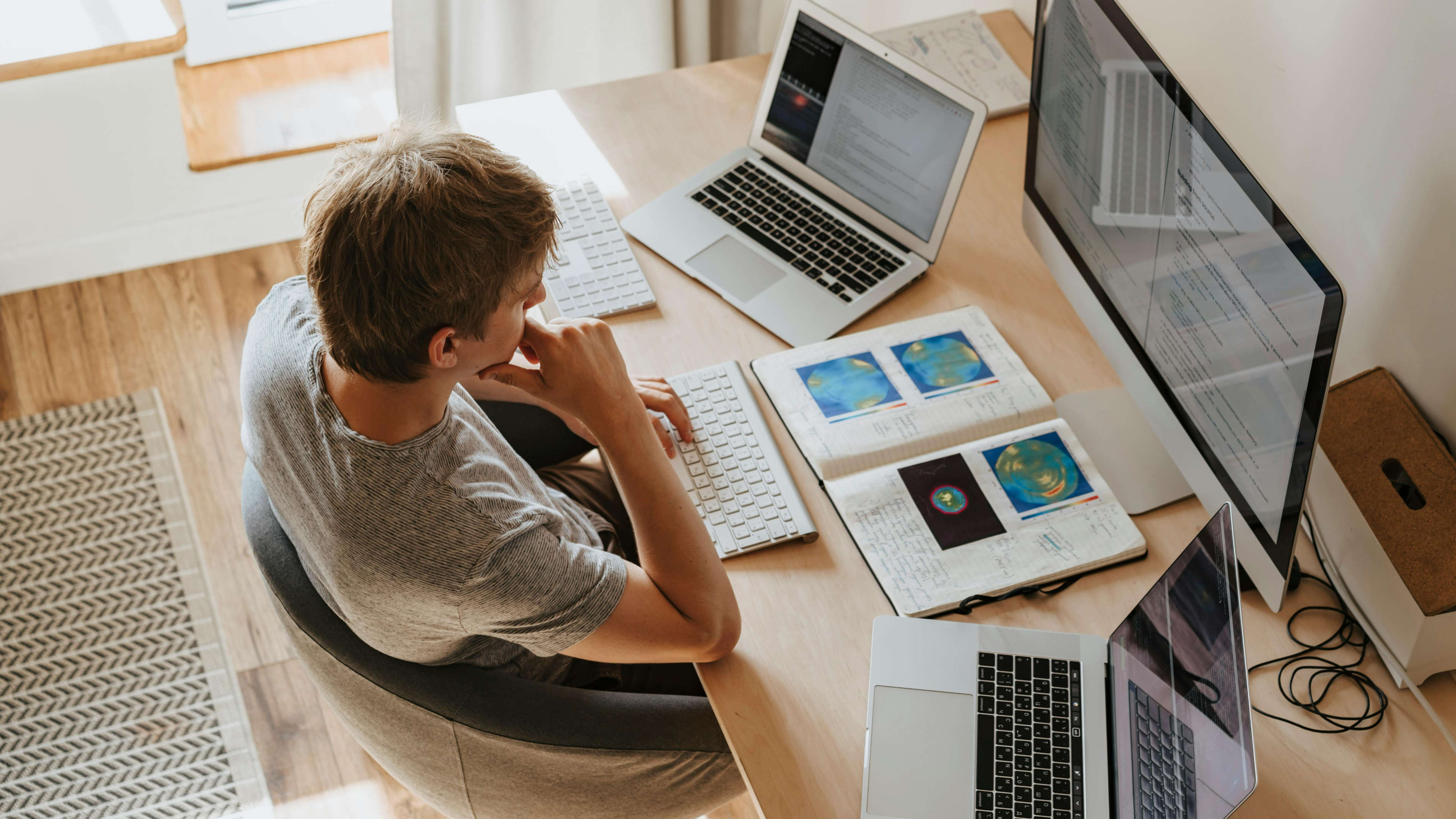 Man at Desk Working With Multiple Computers