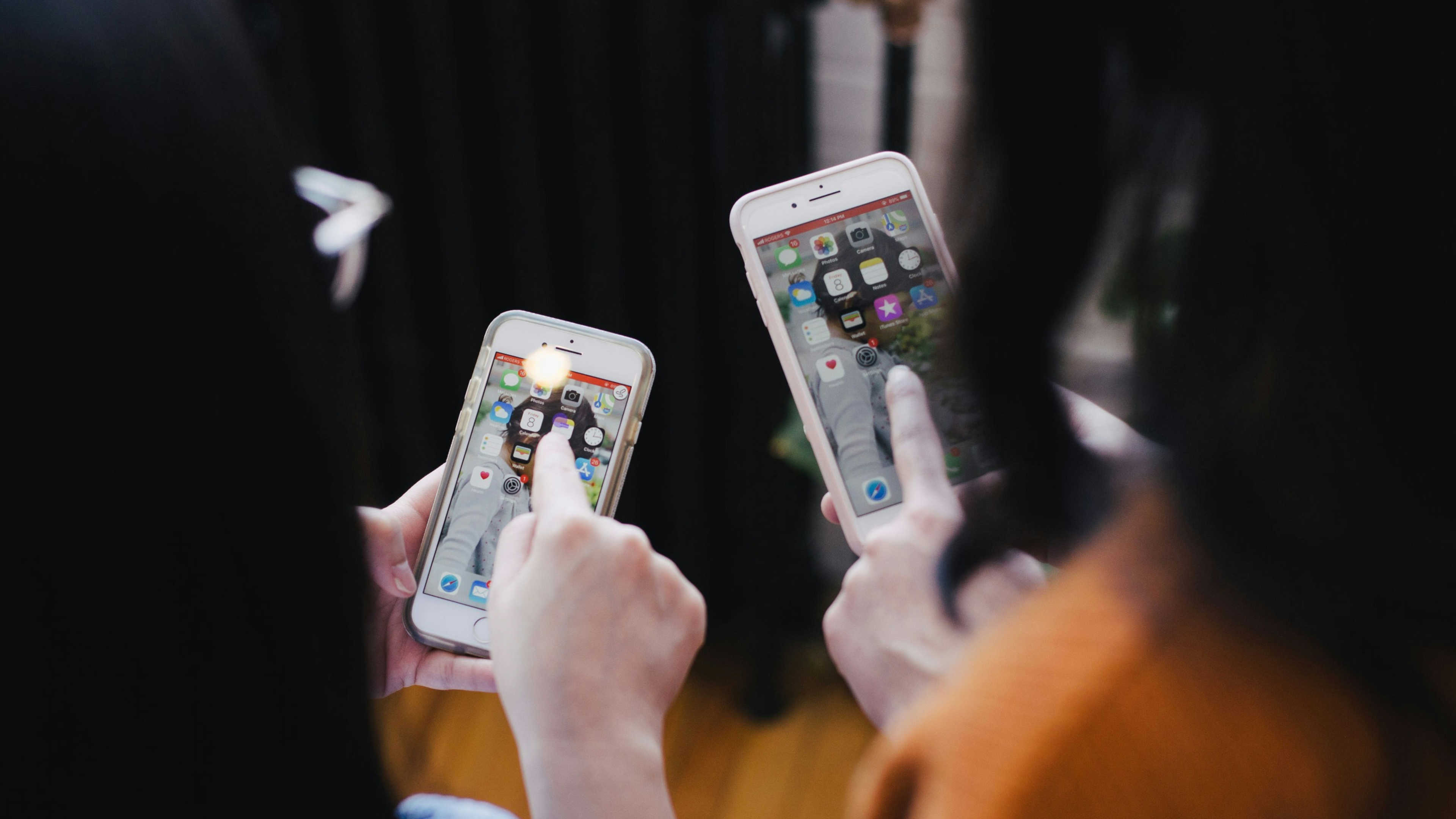 Two girls using their phones