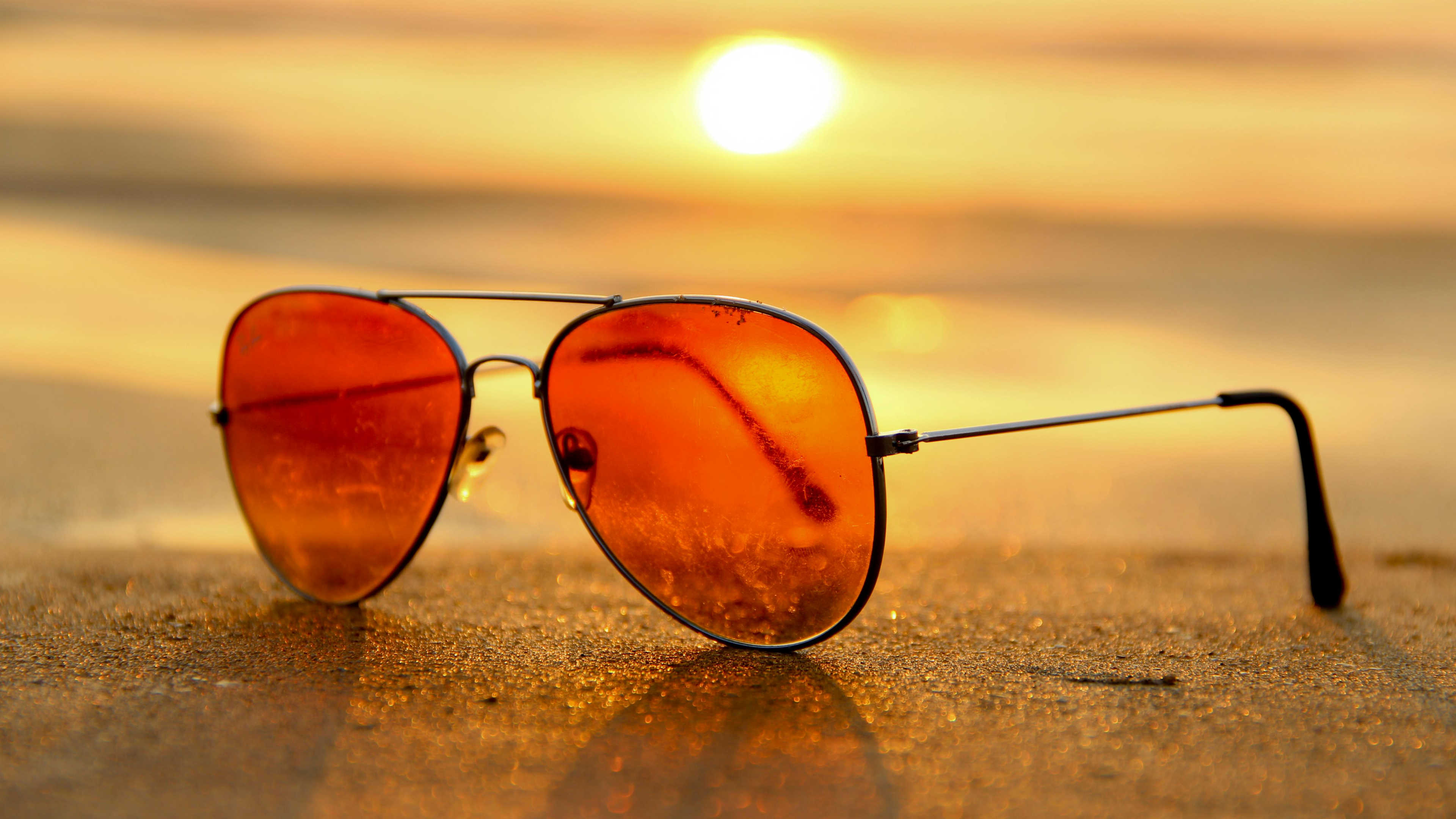 Sunglasses on a table at sunset