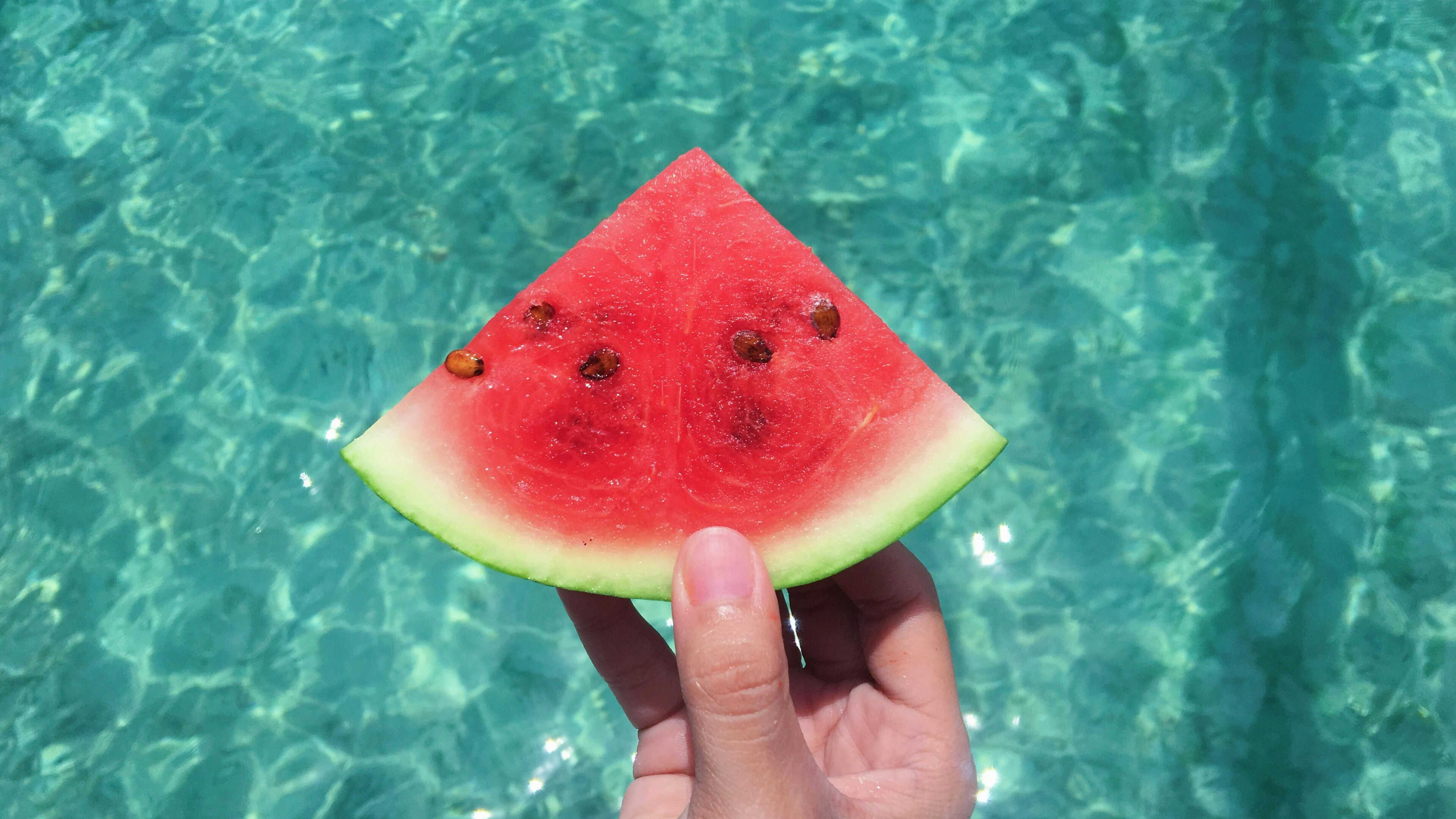 Holding a slice of watermelon