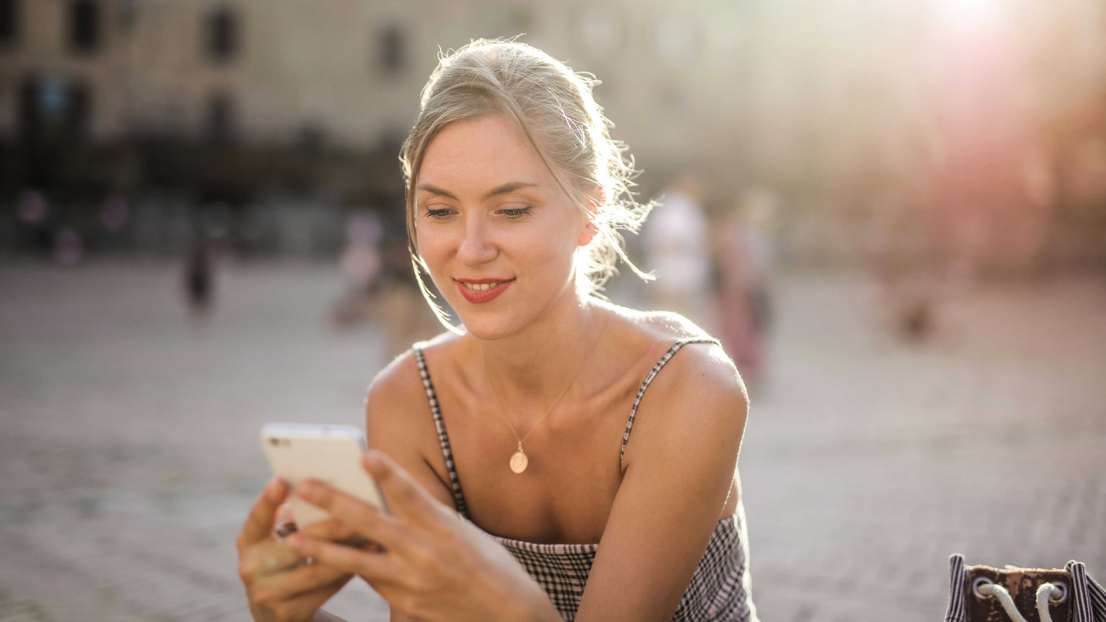 Woman using her mobile phone in a plaza