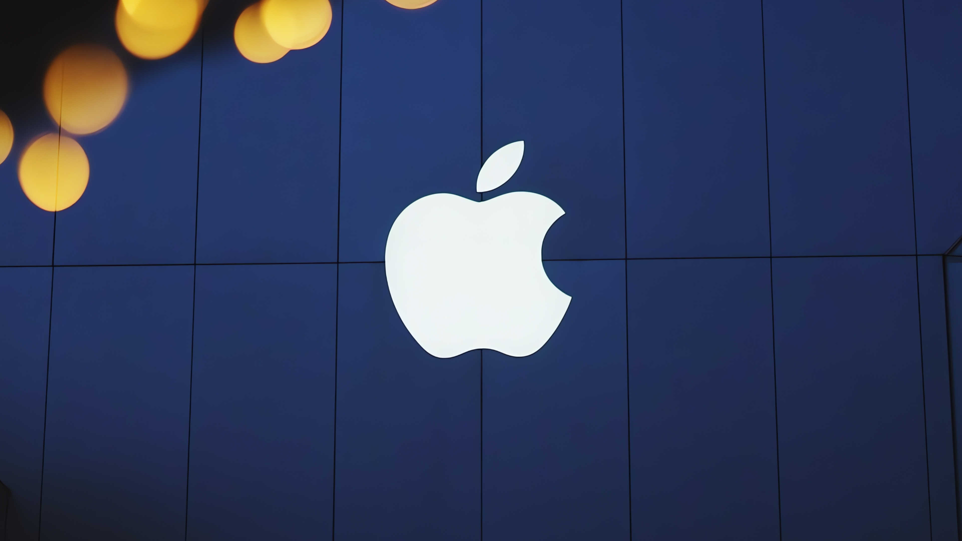 Bright white Apple logo on a storefront