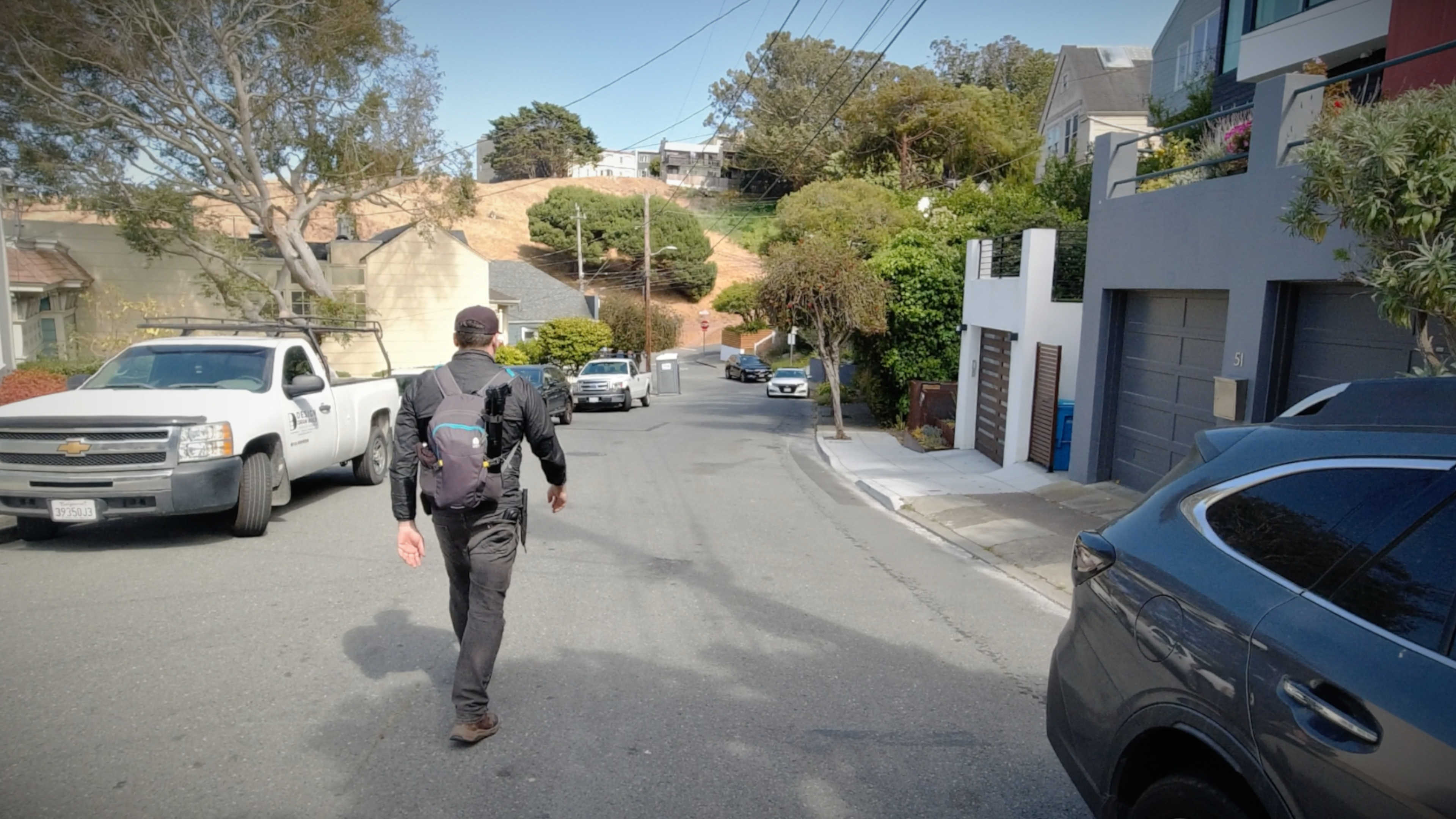 Me walking up to Kite Hill with my backpack and camera gear